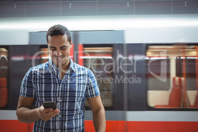 Executive using mobile phone on platform