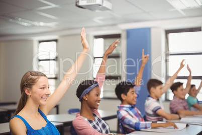 Student raising hand in classroom