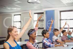 Student raising hand in classroom