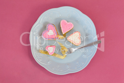 Heart shape gingerbread cookies and fork kept on plate