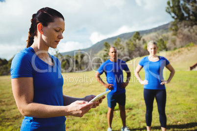 Female trainer using digital tablet