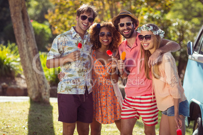 Group of friends enjoying and eating ice lolly