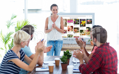 Colleagues clapping hands in a meeting