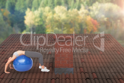 Composite image of fit young woman stretching on fitness ball