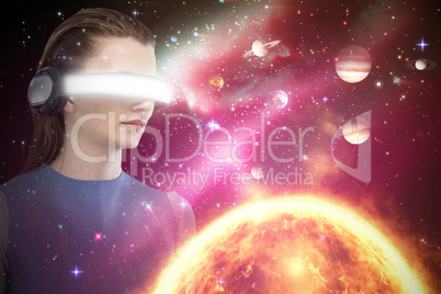 Composite image of beautiful woman using virtual reality headset 3d