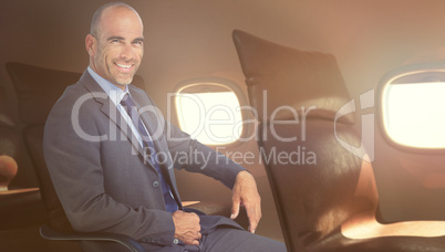 Composite image of portrait of confident businessman sitting on chair