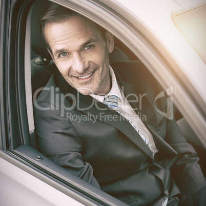 Man sitting in a car looking at camera