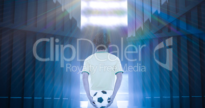Composite image of rear view of football player holding ball at the back 3d