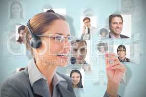 Composite image of businesswoman wearing headset