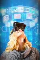 Composite image of happy blond woman using virtual reality headset 3d