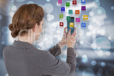 Composite image of businesswoman using mobile phone 3d