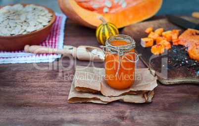 Pumpkin juice in a glass jar on a table
