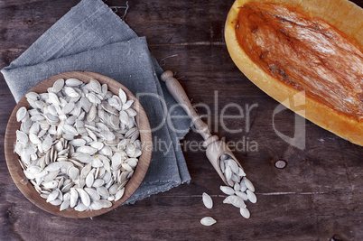 Pumpkin seeds in a wooden bowl