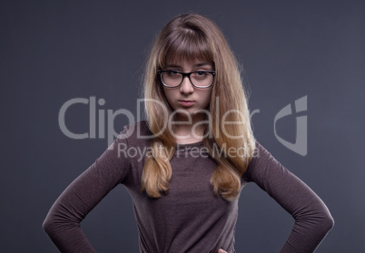 Skeptical teenage girl in glasses