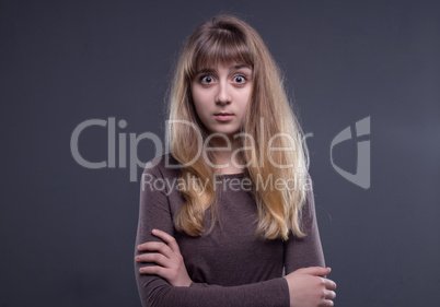 Puzzled blond teenage girl