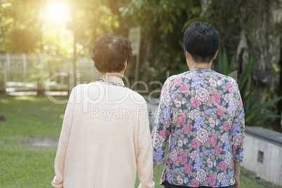 Rear view Asian elderly women walking at outdoor park