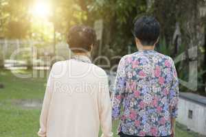 Rear view Asian elderly women walking at outdoor park