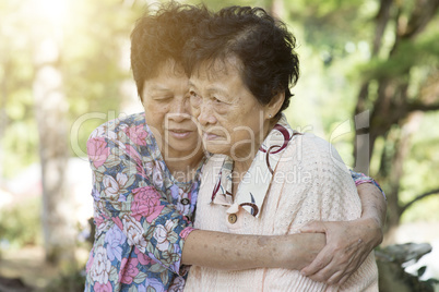 Asian elderly women hugging