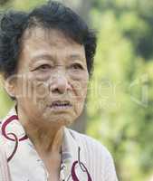 Upset Asian elderly woman