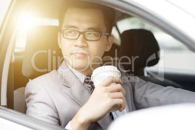 Man drinking coffee while driving