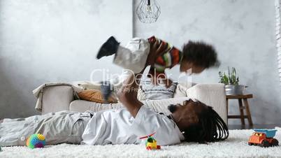 African american father lifting mixed race son up