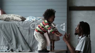 Serious african father parenting his toddler son