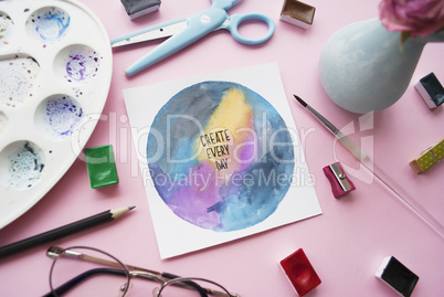 Artist workspace. Inspirational quote create every day , palette, watercolor, brush, glasses. Flat lay
