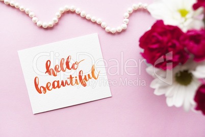 Inspirational quote Hello beautiful written in calligraphy style with watercolor. Composition on a pink background. Flat lay