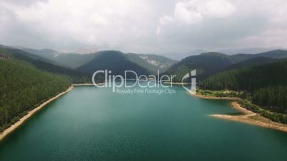 Panoramic aerial view of a lake among the forests and mountains