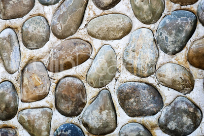 A fragment of a wall , decorated with sea pebbles (Background im