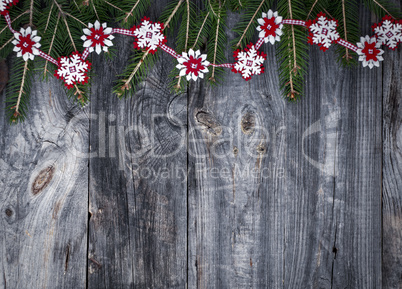 Festive garland of fir branches and decorative felt snowflakes