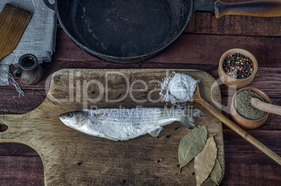 Frozen fish smelt on a kitchen cutting board