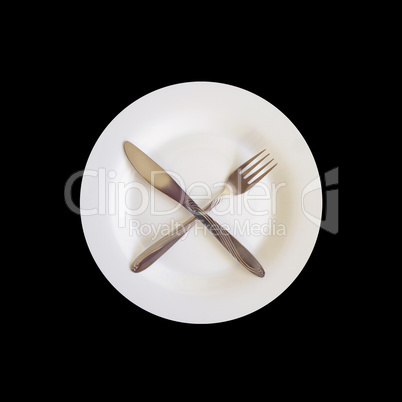 knife and fork on the plate isolated on the black