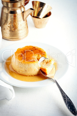 Creme Caramel on a plate served on a table