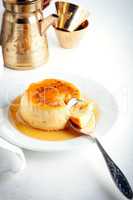 Creme Caramel on a plate served on a table