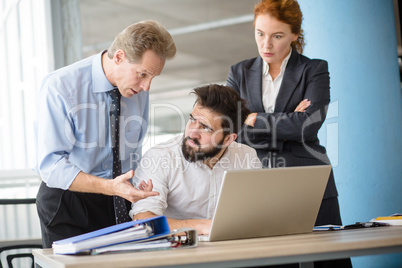 Angry boss screaming at workers