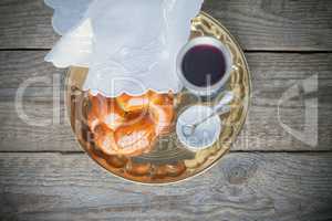 Wine, challah on a wooden surface