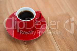 Black coffee served in red cup