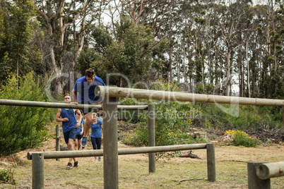 People jumping over the hurdles during obstacle course