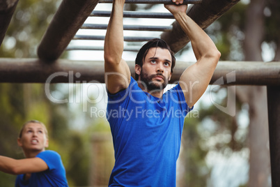 Fit man climbing monkey bars