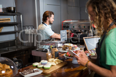 Two male staff working at counter