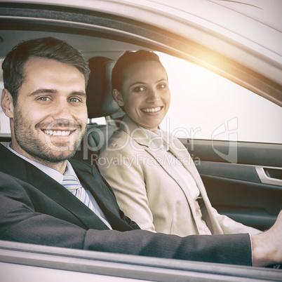 Couple in a car looking at the camera