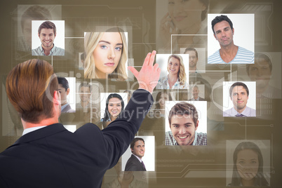Composite image of rear view of businessman pointing with his fingers