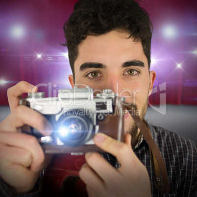 Composite image of casual man taking a photo