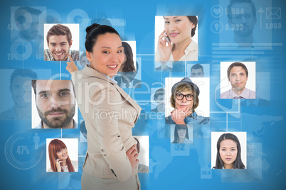 Composite image of smiling asian businesswoman pointing