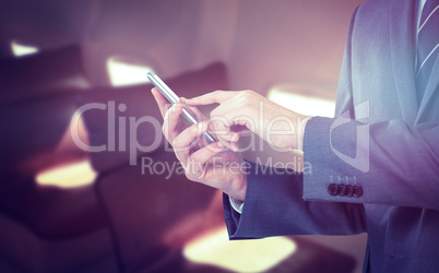 Composite image of midsection of businessman using mobile phone