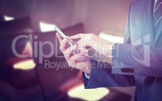 Composite image of midsection of businessman using mobile phone