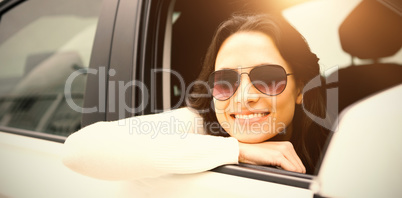 Woman wearing sunglasses in her car