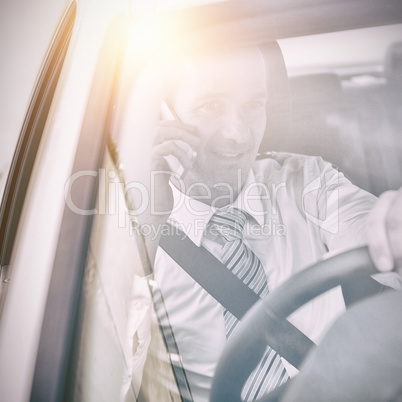 Man driving a car and using his phone