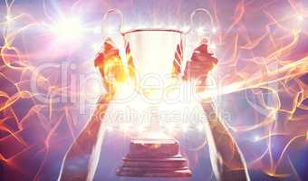 Composite image of composite image of cropped hand of athlete holding 3dtrophy